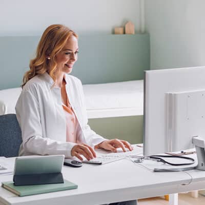 Doctor in lab coat at computer