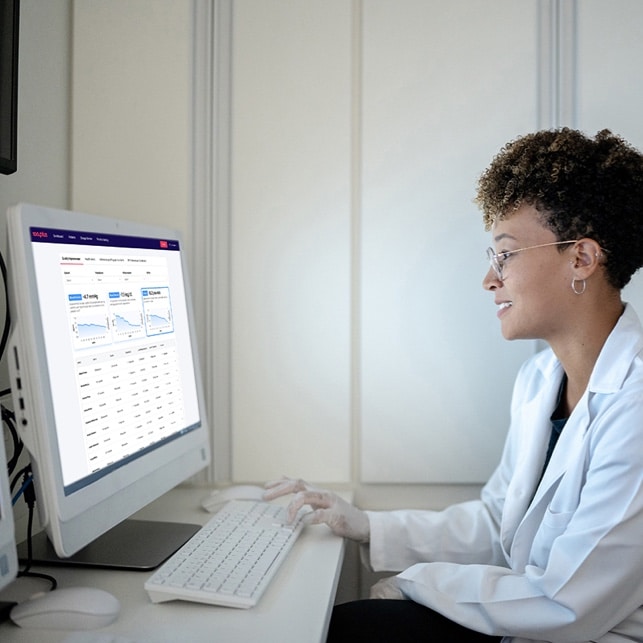 Doctor Reviewing Patient Readings at Computer