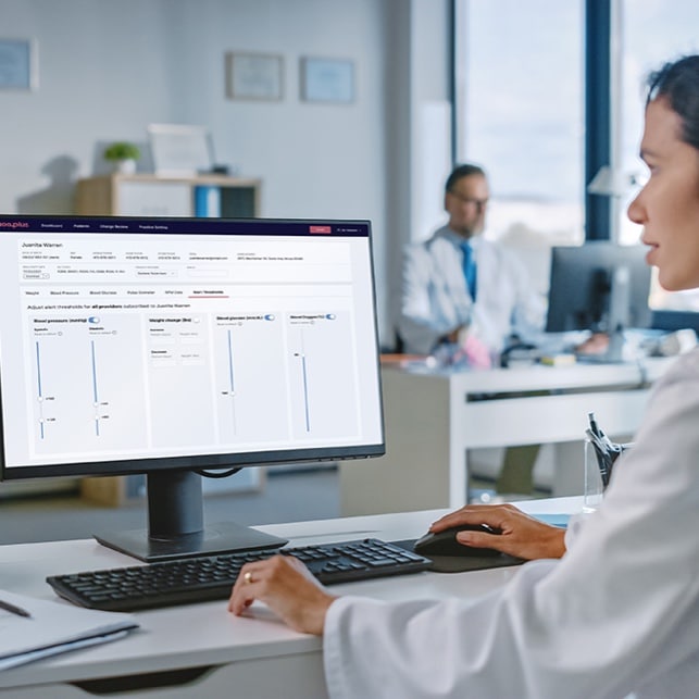 Woman At Computer With Visible Screen