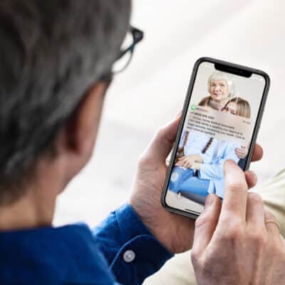 Man Holding Phone With Text From Esper