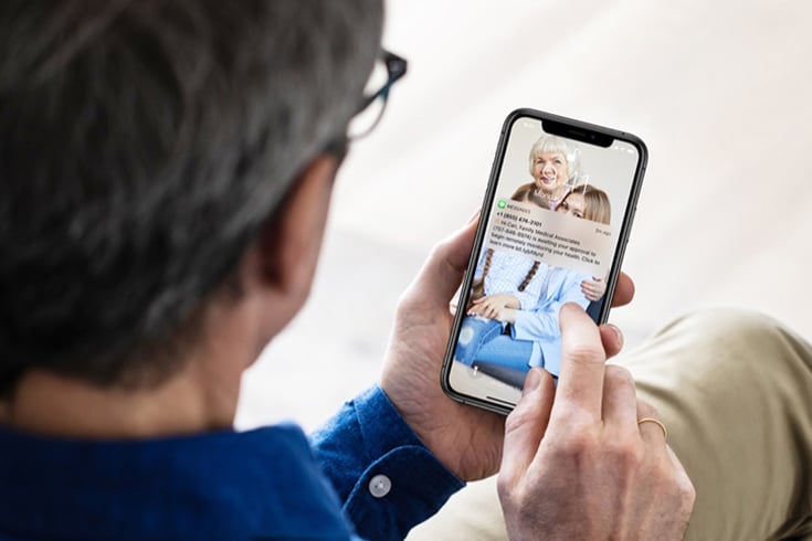 Man Holding Phone With Text From Esper