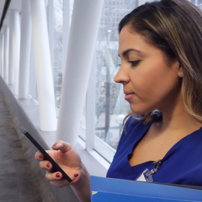 Nurse Reviewing Patient Readings on Phone