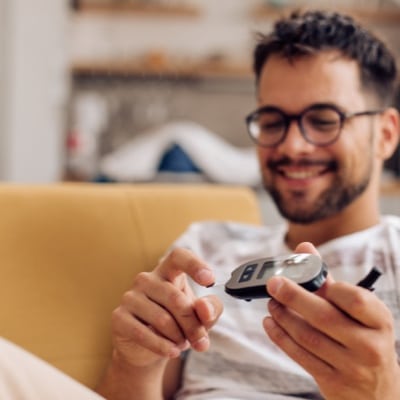 Man taking blood glucose reading